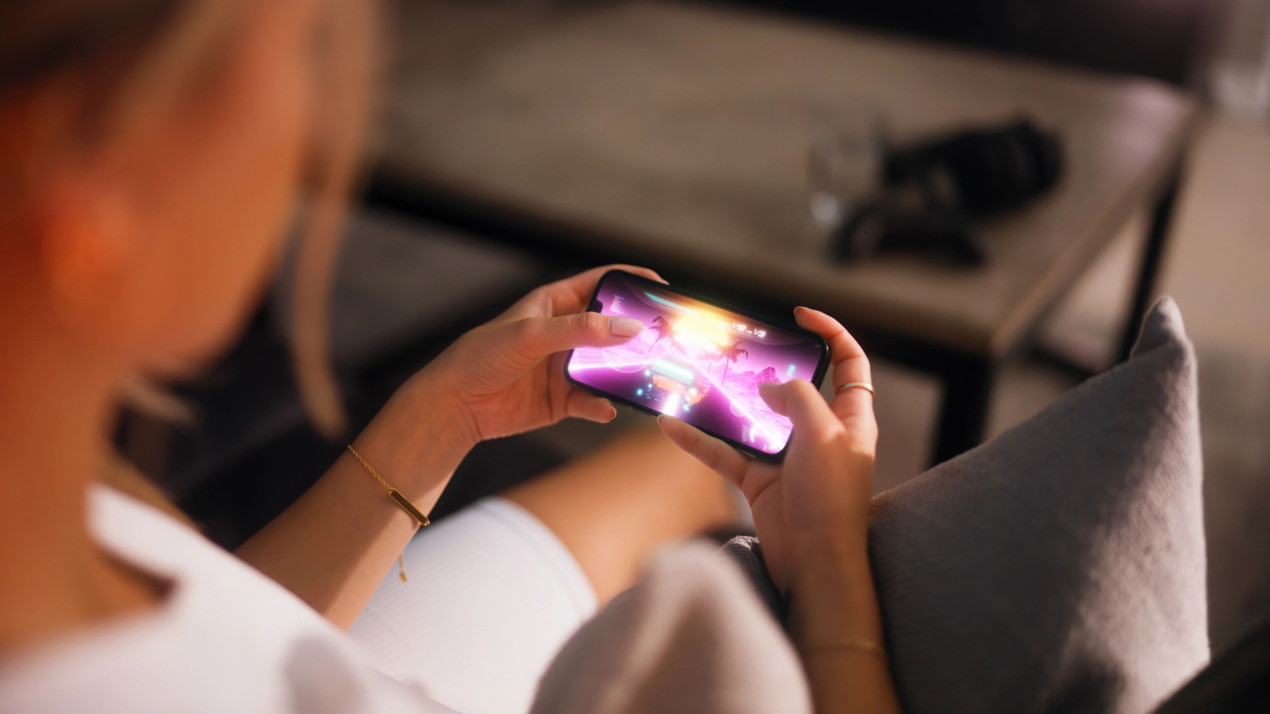 Woman playing a mobile racing game on a smartphone
