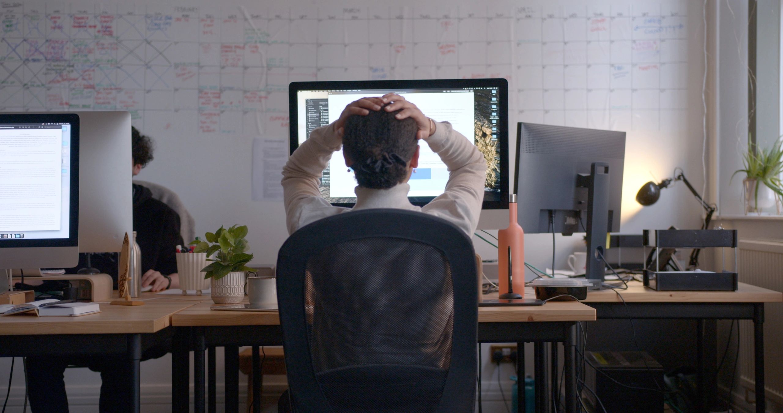 Mobile app developer working at a computer
